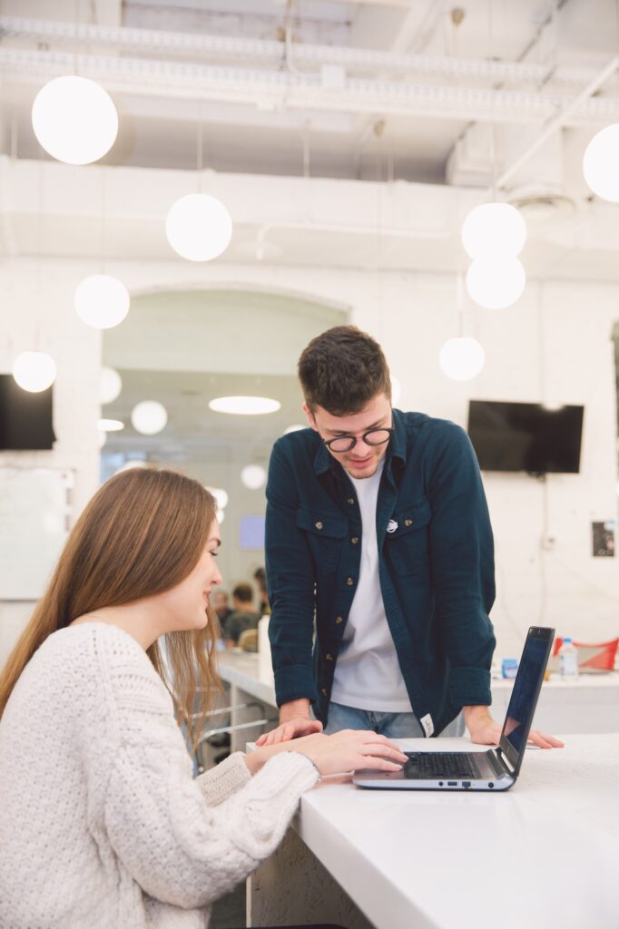 Man and woman at desk with laptop | What Do You Need To Be An HR Consultant? | Business & Education | Elle Blonde Luxury Lifestyle Destination Blog | Why Employee Engagement Is Important For Your Business