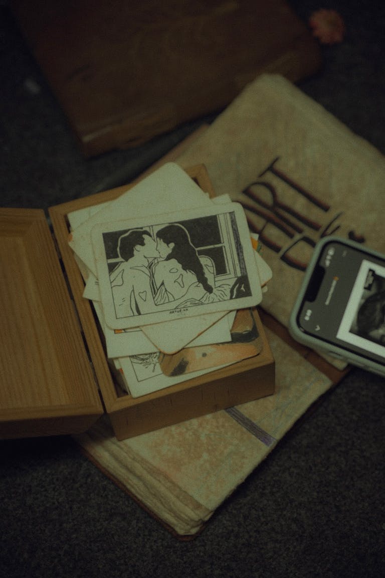 A collection of vintage photos and art on a textured surface with a nostalgic feel.