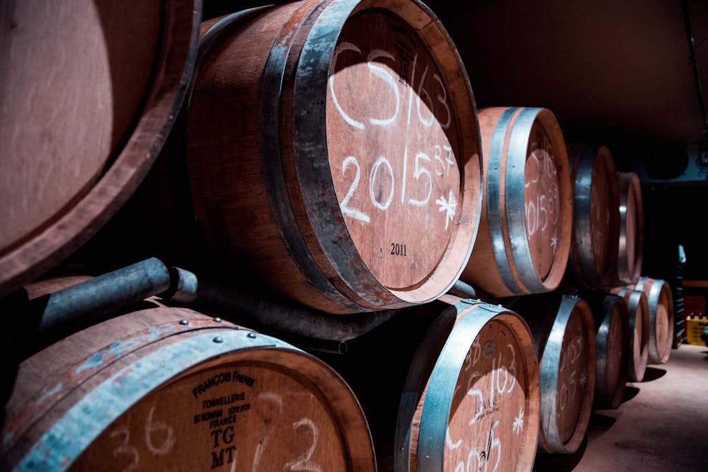 Hidden Wine Cellars and Tasting Rooms in Central London 3 A dimly lit cellar in Stellenbosch, South Africa, showcasing stacked wooden wine barrels.