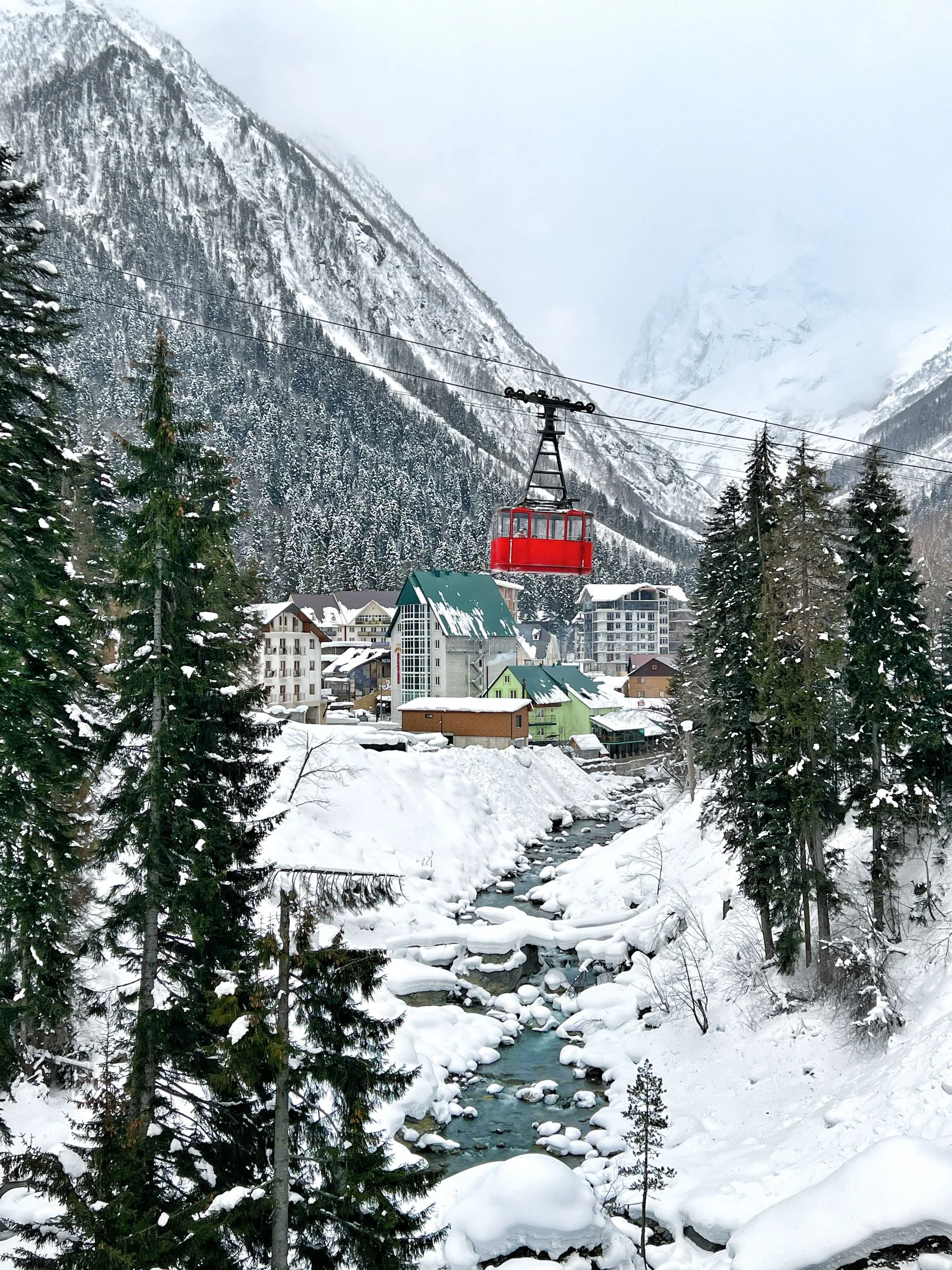Explore the winter wonderland of Dombai Resort, featuring a majestic cable car and snow-covered mountains in Russia.