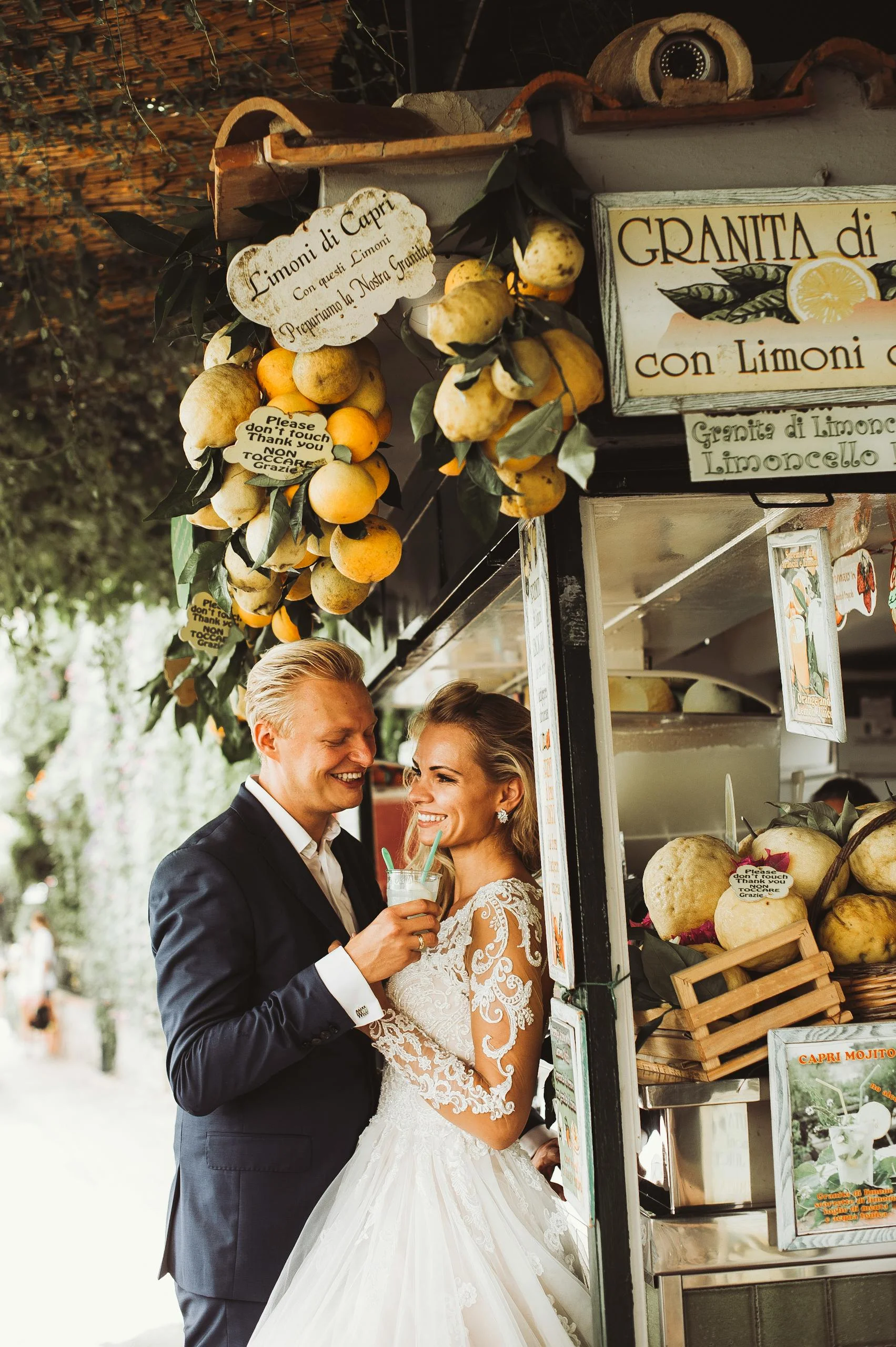 Newlywed couple enjoying a sweet moment with lemon granita in Capri, Italy.