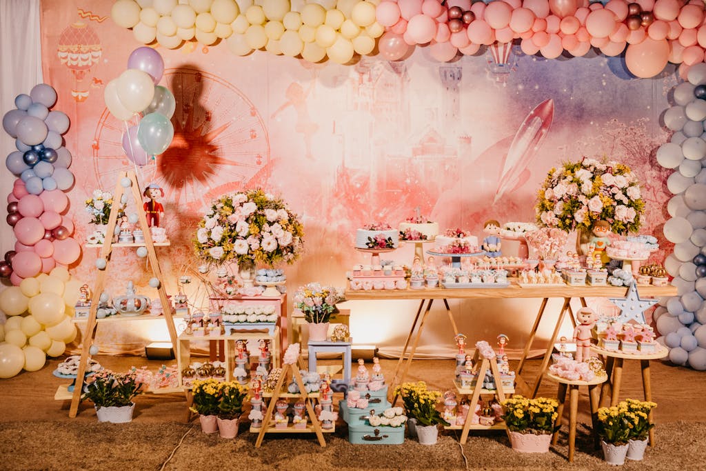 An inviting candy bar with balloons and floral decor for a festive celebration indoors.