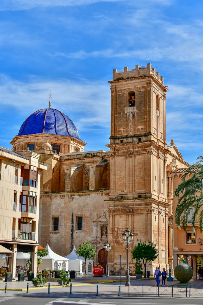 7-Day Costa Blanca Slow Living Itinerary: Alicante Villages, Coastal Towns & Inland Escapes 3 Beautiful historic cathedral with a blue dome in Elche, Spain, captured under a clear blue sky.