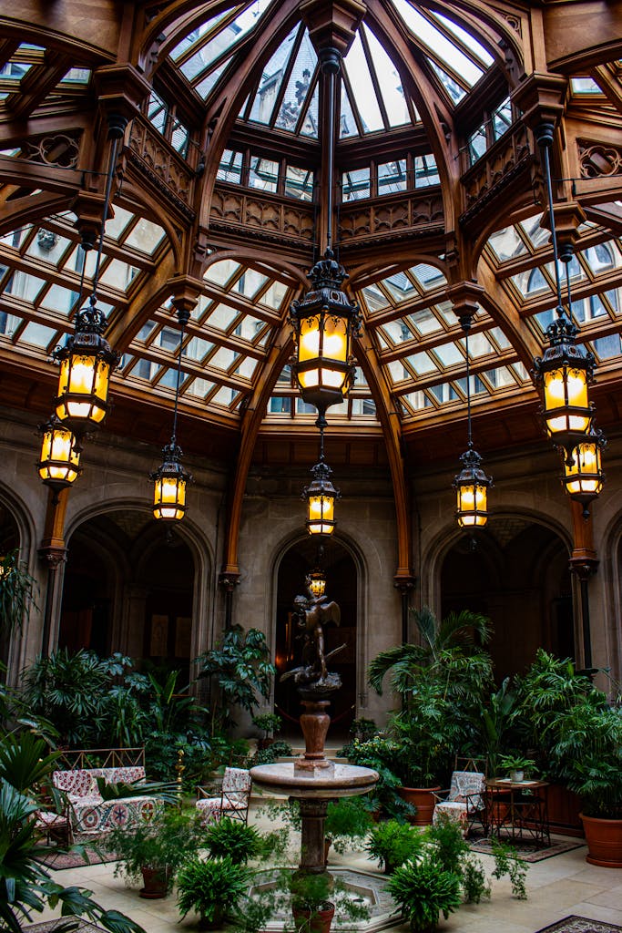 The World’s 10 Most Mindful Travel Destinations 5 Captivating view of the Biltmore Estate's dome and green-filled atrium featuring elegant lanterns and classical architecture.