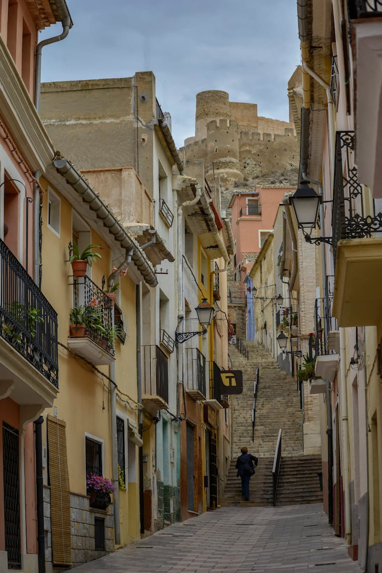 Charming alley in Biar, Spain, leading to an ancient castle. Rich cultural heritage.