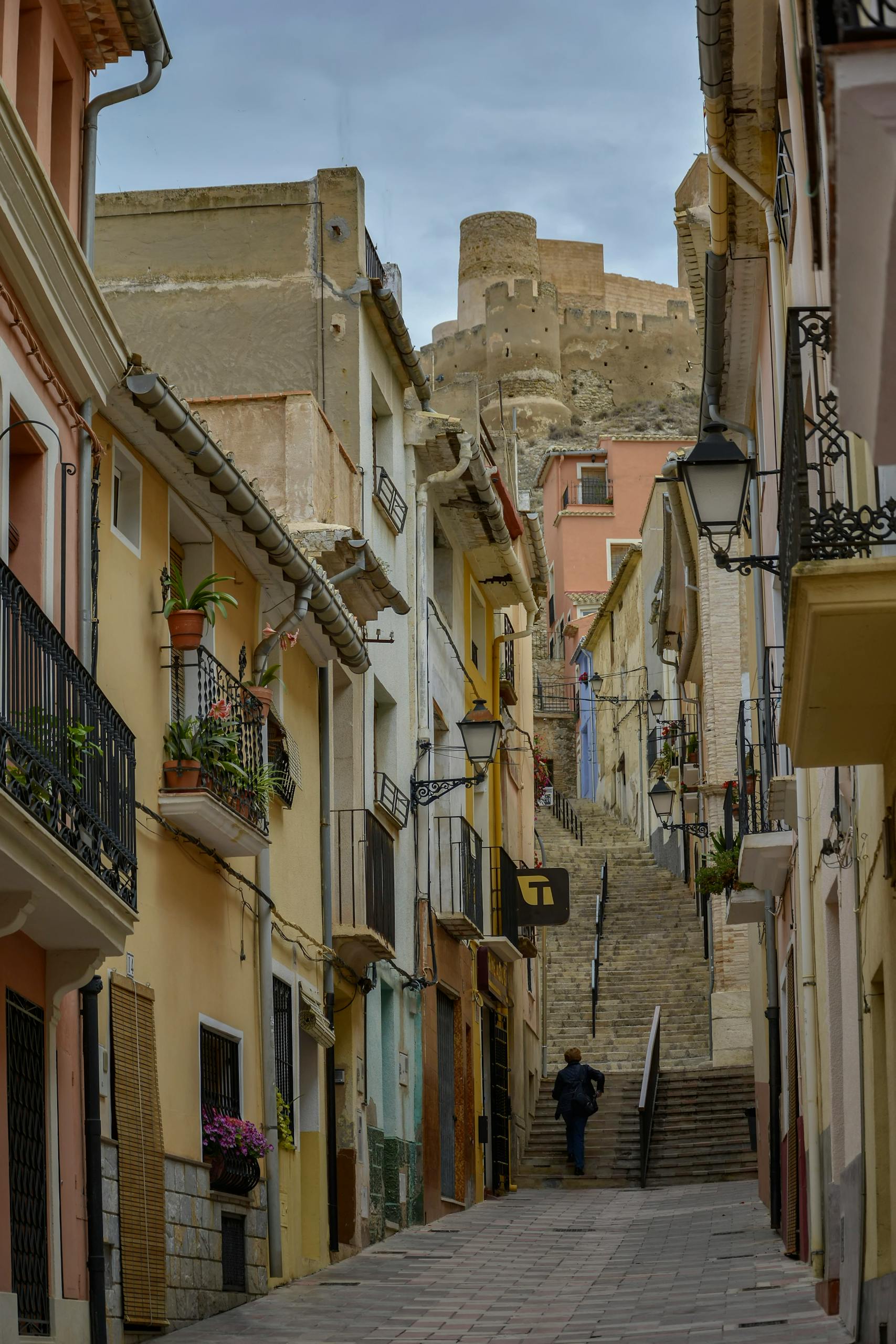 Charming alley in Biar, Spain, leading to an ancient castle. Rich cultural heritage.