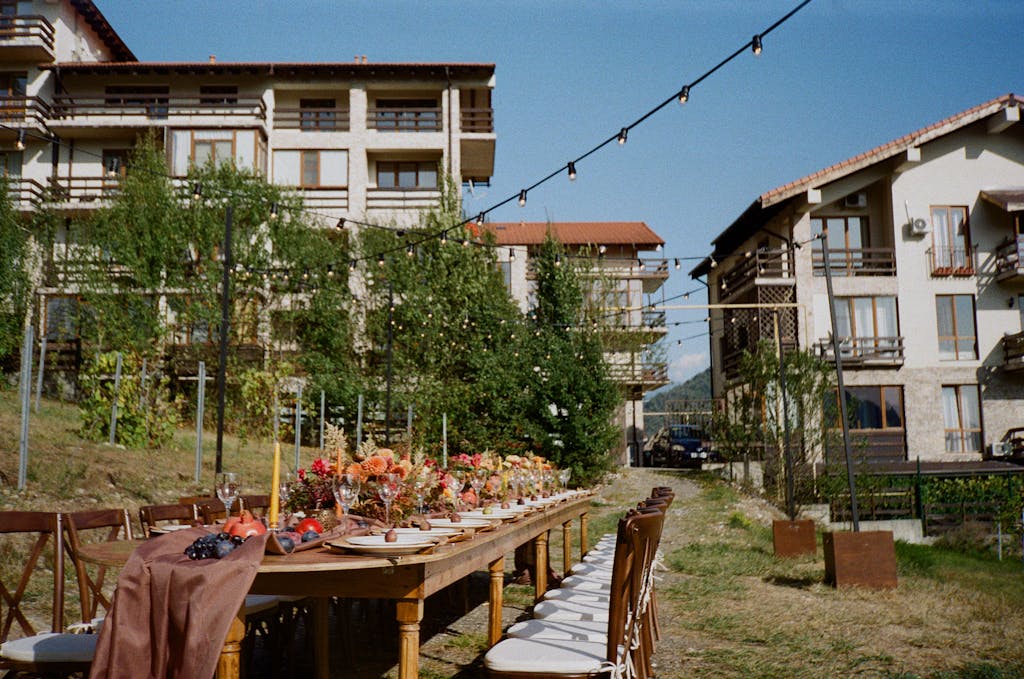 Hangover Recovery Routine - How to Wake Up Looking Polished After a Late Night 3 Charming outdoor dining setup with flowers and string lights in Krasnaya Polyana, Russia.