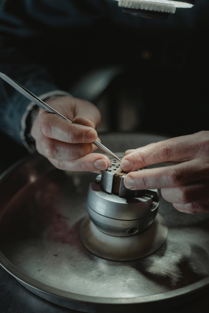 The Old Money Etsy Christmas Gift Guide: Luxe Gifts That Whisper, Not Shout 3 Detailed view of hands crafting jewelry using precision tools on a workbench. Ideal for artistry and craftsmanship themes.