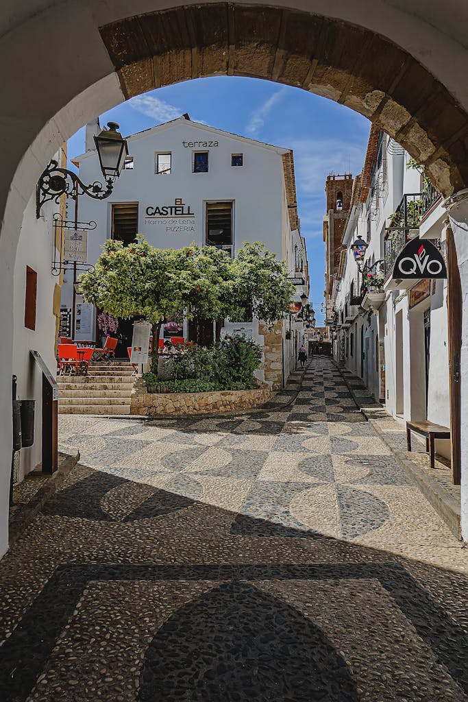 Explore the picturesque cobblestone passageways and whitewashed buildings of Altea's old town in Spain.