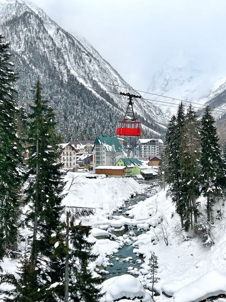 Explore the winter wonderland of Dombai Resort, featuring a majestic cable car and snow-covered mountains in Russia.