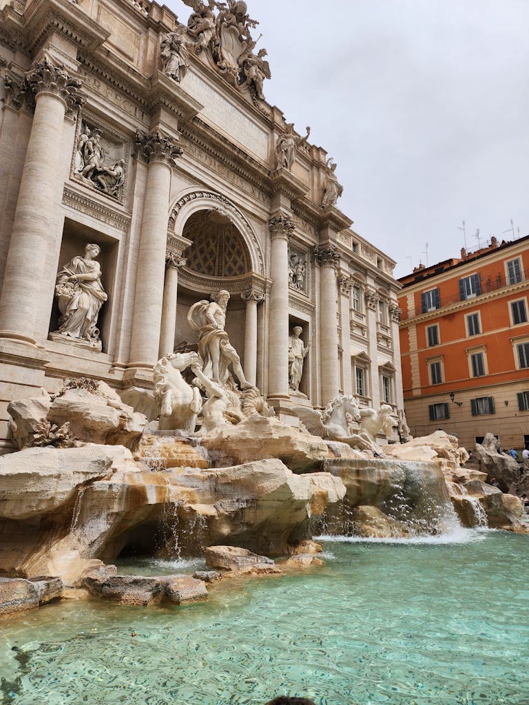 Majestic Trevi Fountain in Rome with detailed sculptures and turquoise water.