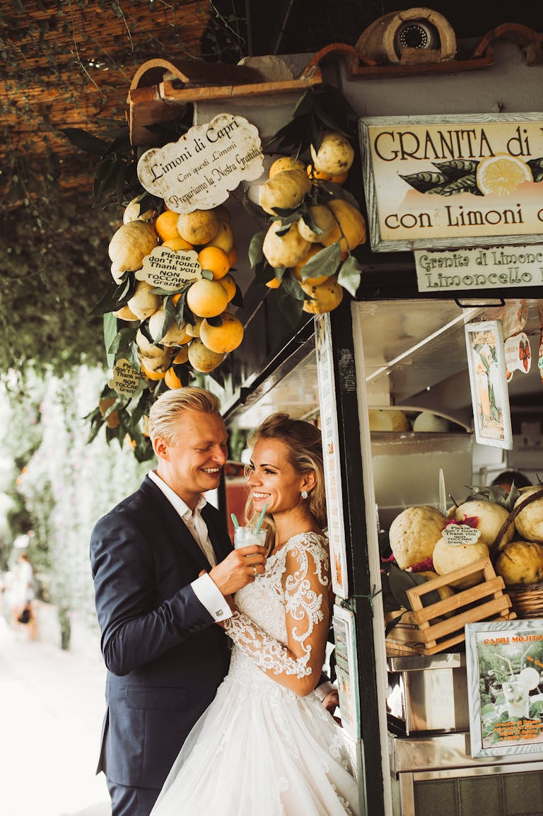 Newlywed couple enjoying a sweet moment with lemon granita in Capri, Italy.