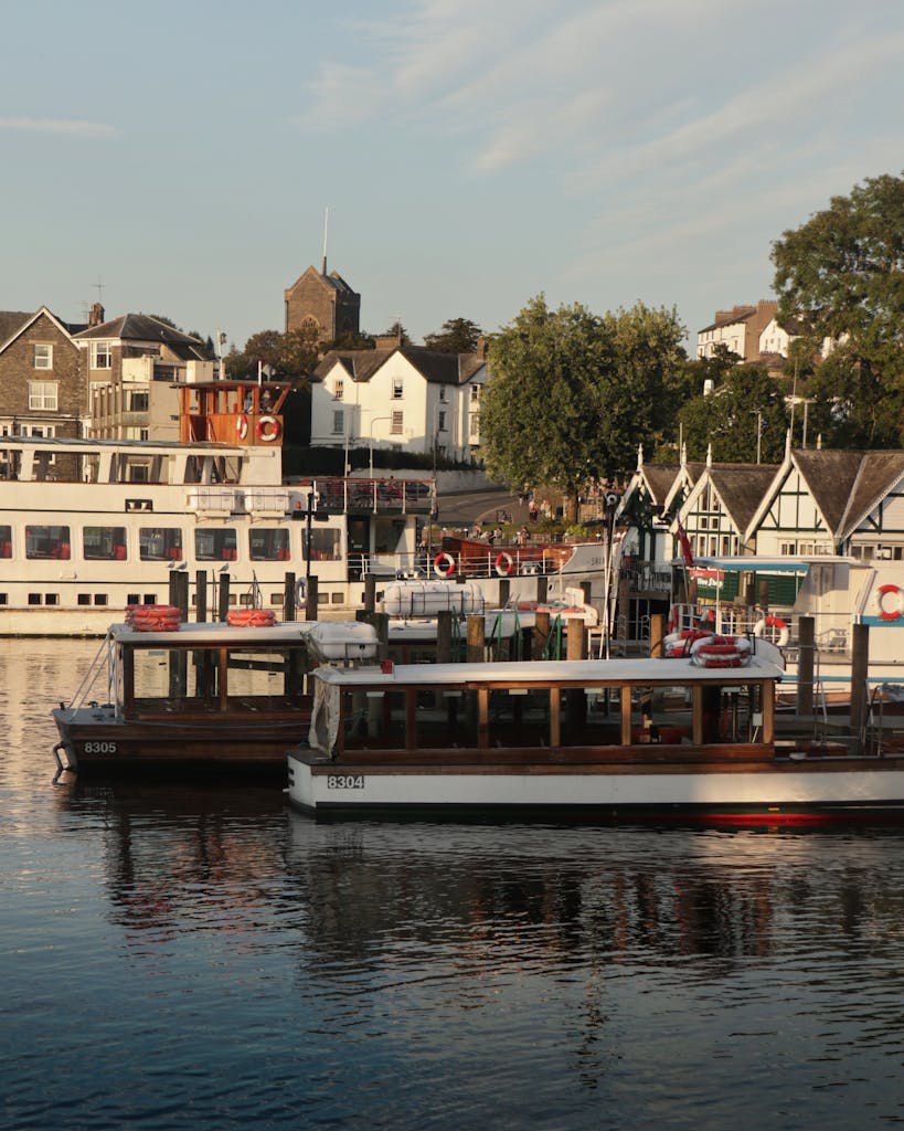 What to Look for in Luxury Dog Friendly Cottages in the UK 3 Peaceful sunset scene at Lake Windermere with boats docked and golden light on the town.