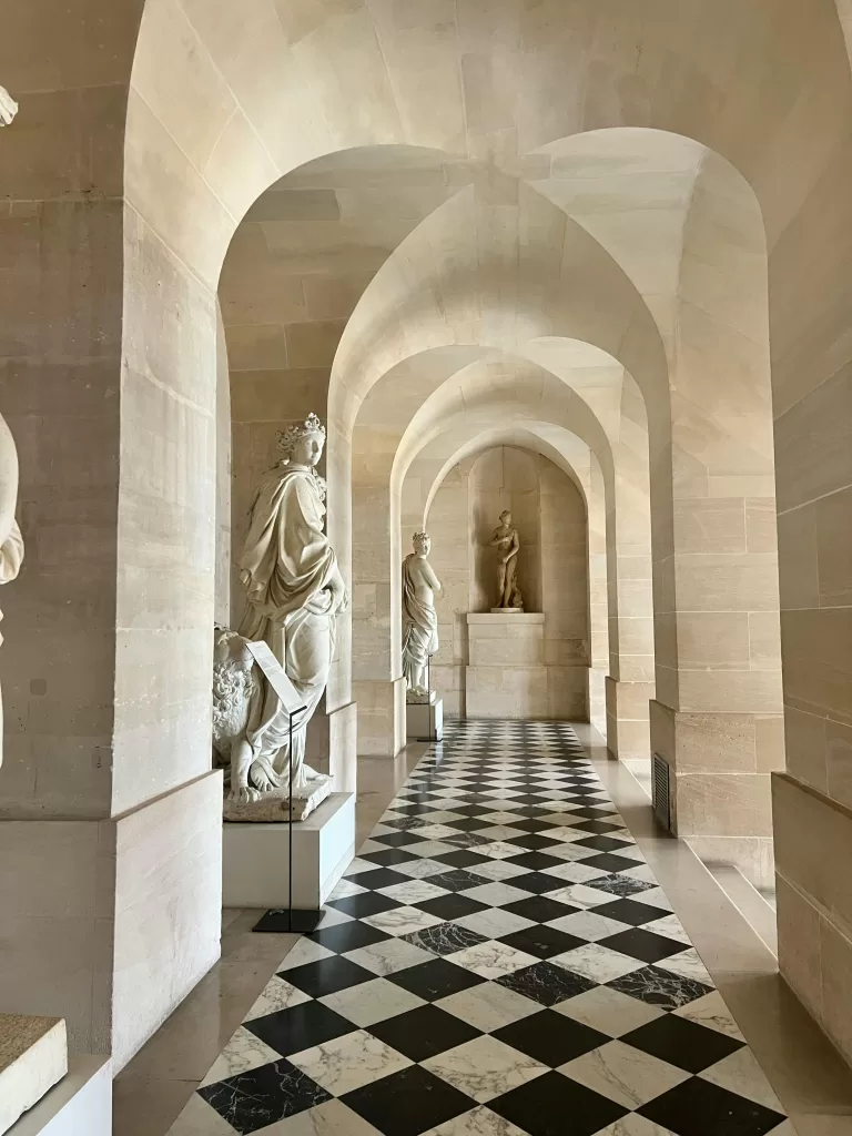 How to Make Pinterest Work Without Posting Every Day 1 "A timeless marble hallway lined with classical statues and a checkerboard floor at a grand European palace — evoking the sophistication of old-world luxury travel.