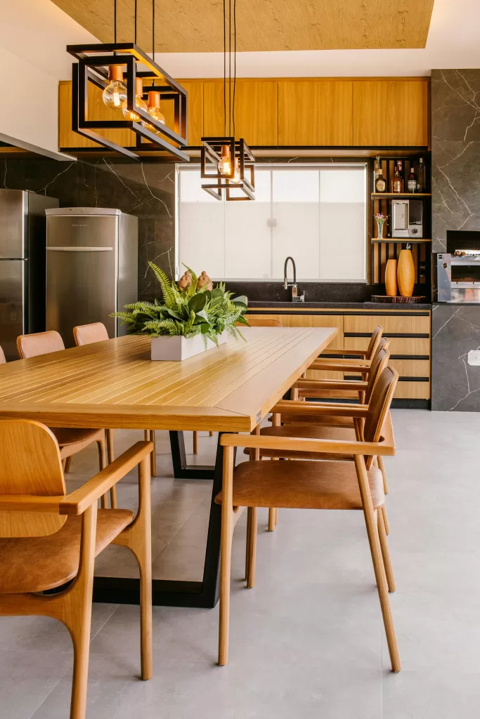 10 Essentials For Choosing A New Kitchen 1 A contemporary luxury kitchen and dining space featuring sleek wood cabinetry, minimalist pendant lighting, and a modern dining table set for six — capturing the refined elegance of a high-end vacation villa or upscale serviced apartment. | How to Prepare for a Kitchen Extension in Your Renovation | Home Interiors | Elle Blonde Luxury Lifestyle Destination Blog