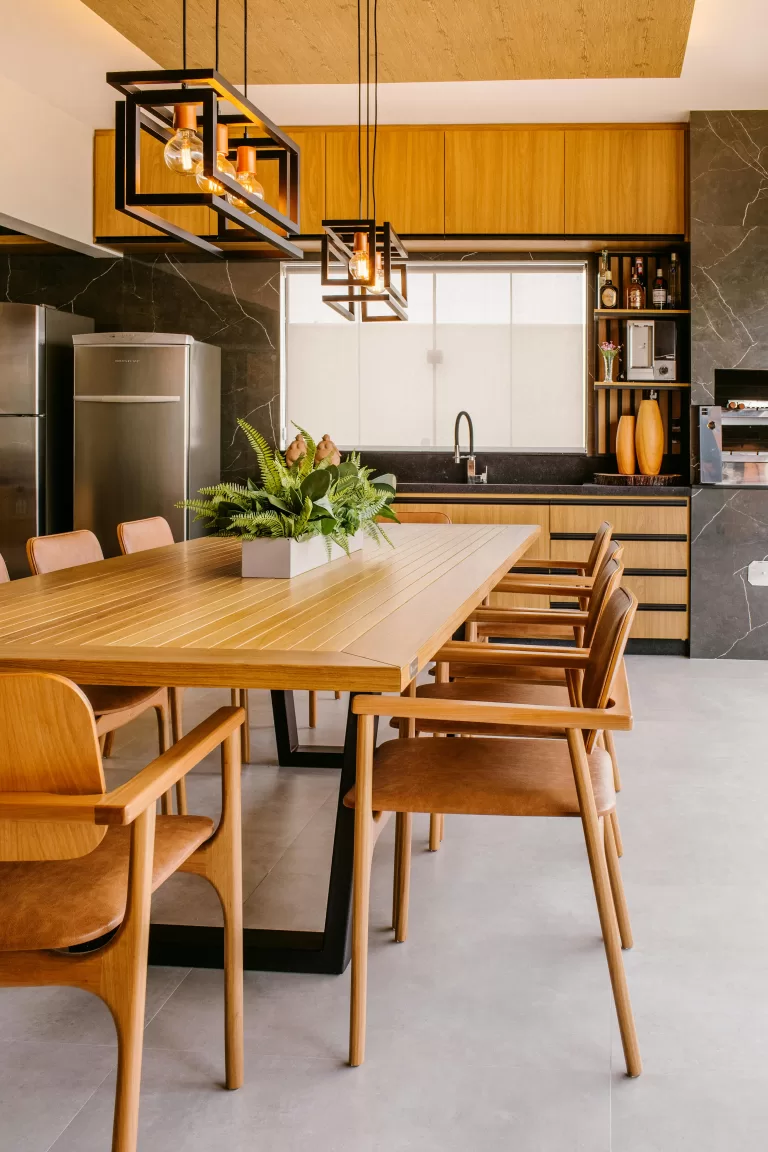 A contemporary luxury kitchen and dining space featuring sleek wood cabinetry, minimalist pendant lighting, and a modern dining table set for six — capturing the refined elegance of a high-end vacation villa or upscale serviced apartment. | How to Prepare for a Kitchen Extension in Your Renovation | Home Interiors | Elle Blonde Luxury Lifestyle Destination Blog