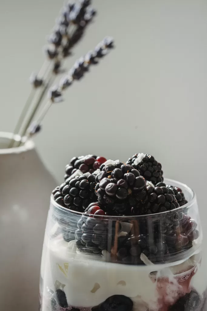 5 Restorative Techniques to Recharge After a Long Flight 5 A luxurious breakfast parfait layered with creamy yogurt, berries, and topped with fresh blackberries, styled with dried lavender in a ceramic vase perfect for a serene morning in a high end boutique hotel. | Elle Blonde Luxury Lifestyle Destination Blog
