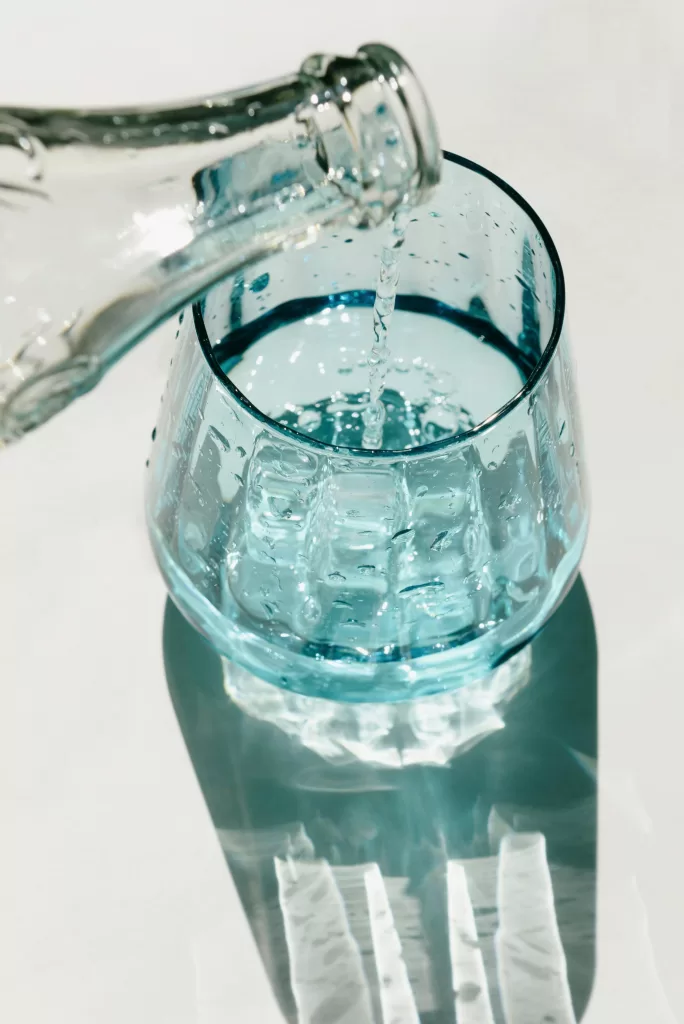 4 Important Reasons You Should Never Drink Champagne Mid Flight 3 Water out of Glass Bottle | 4 Important Reasons You Should Never Drink Champagne Mid Flight | Travel Tips | Elle Blonde Luxury Lifestyle Destination Blog