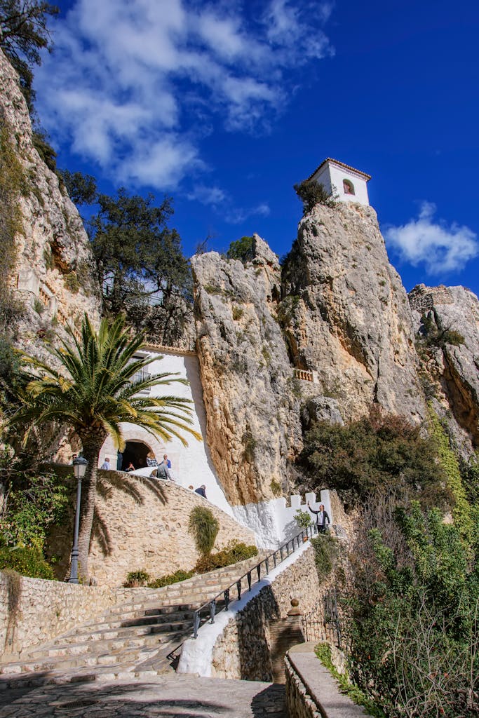 Guadalest, Alicante: A Slow Living Itinerary for Spain’s Most Dramatic Mountain Village 3 Scenic view of Guadalest Castle in Spain, nestled on a rocky cliff under a clear blue sky.