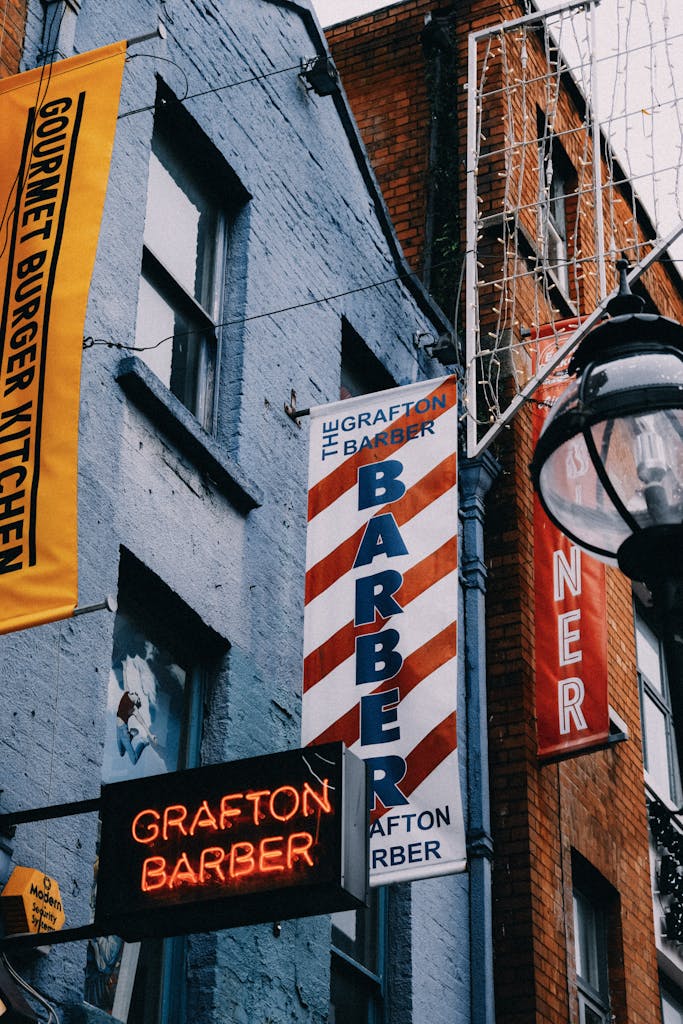 Priority Outdoor Advertising Agency: What They Do and Who They Help 3 Vibrant street view featuring barber shop and restaurant signs in an urban setting. Outdoor Advertising